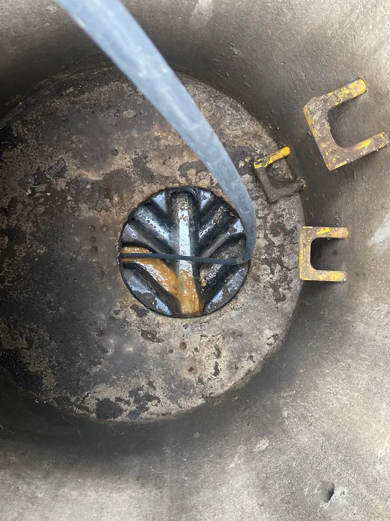 Equipment being inserted into a drain manhole