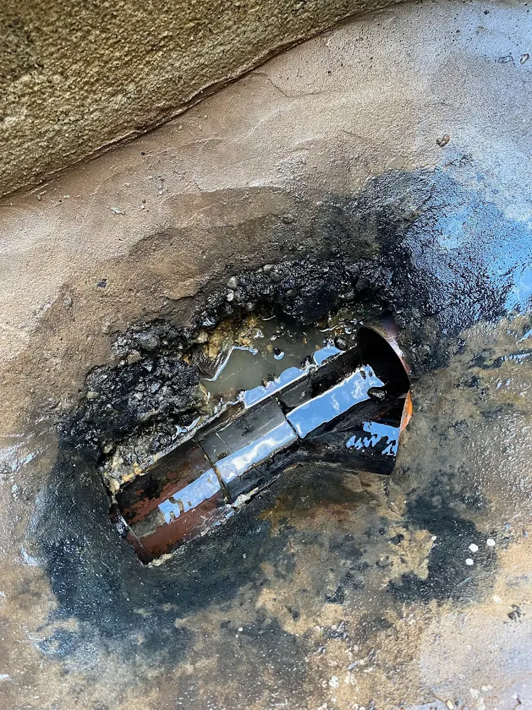 A picture of a blocked outdoor drain.